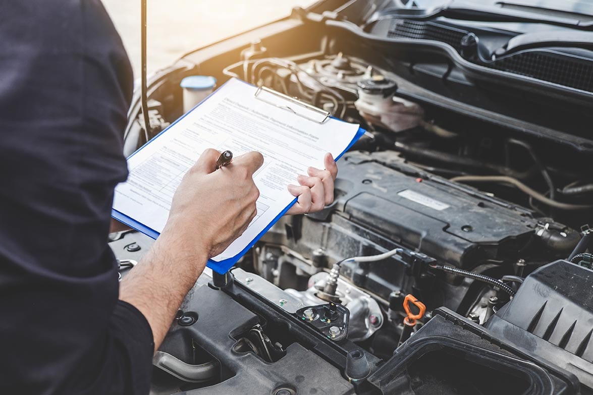 person-holding-check-list-for-car-inspection